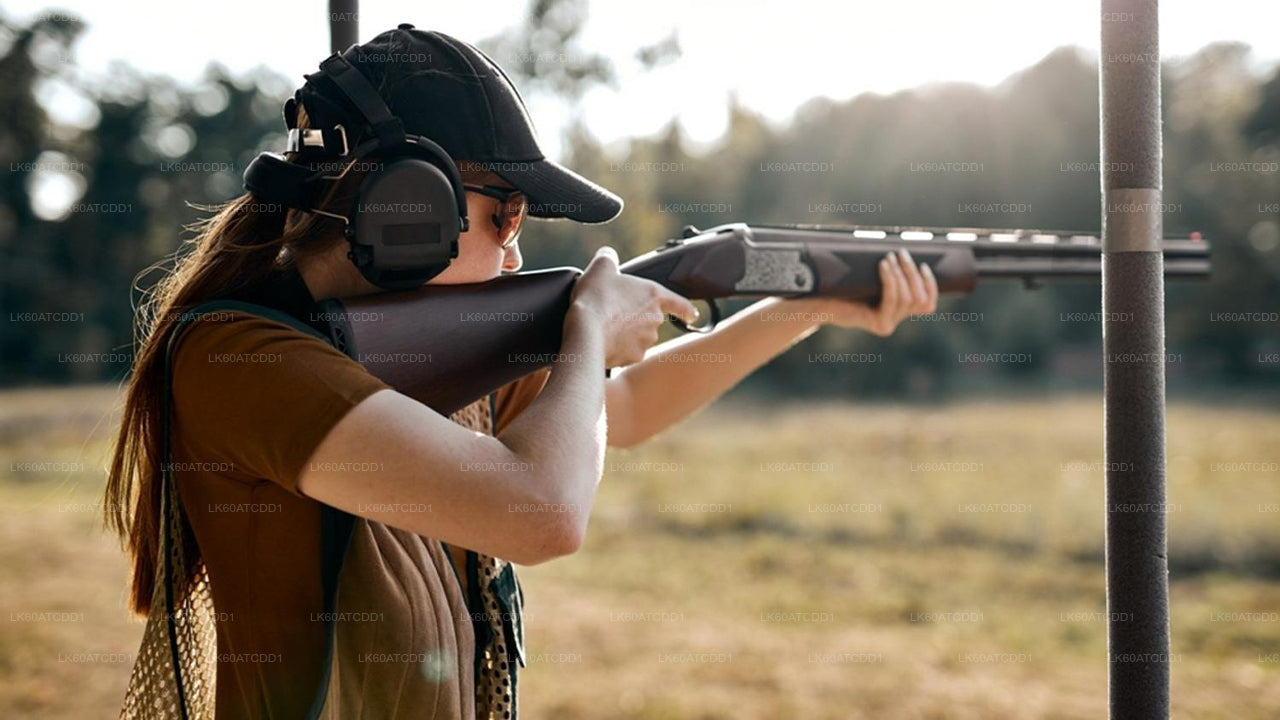 Person holding a rifle in an outdoor setting