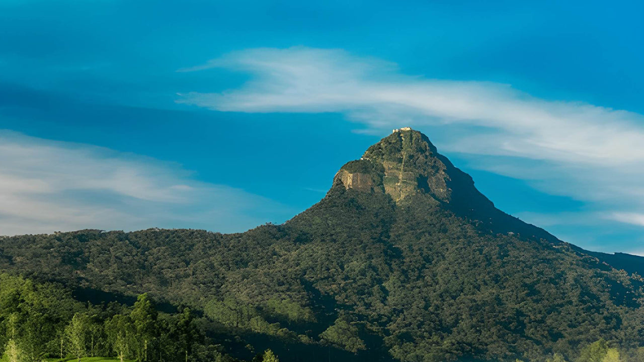 Mountain peak with a clear blue sky and some clouds